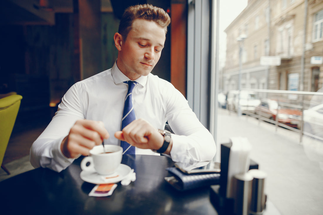 A Finance Bro drinking coffee and looking at an expensive watch